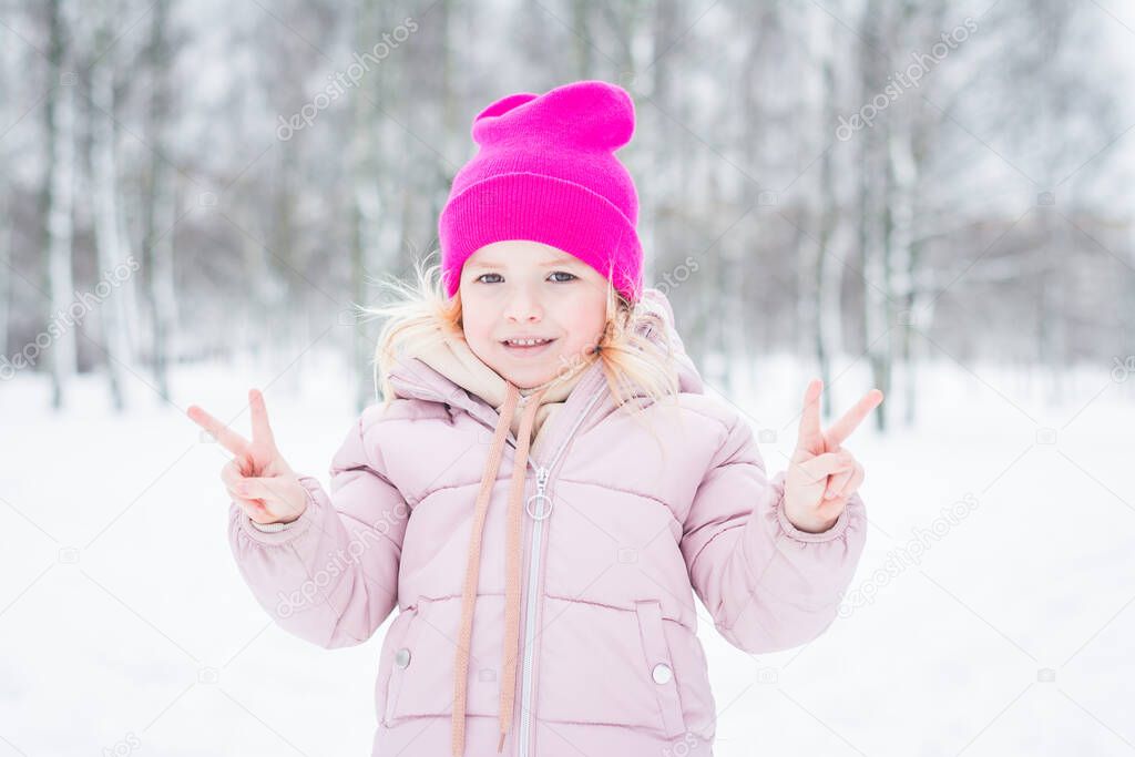 Beautiful little girl portrait in winter in the park