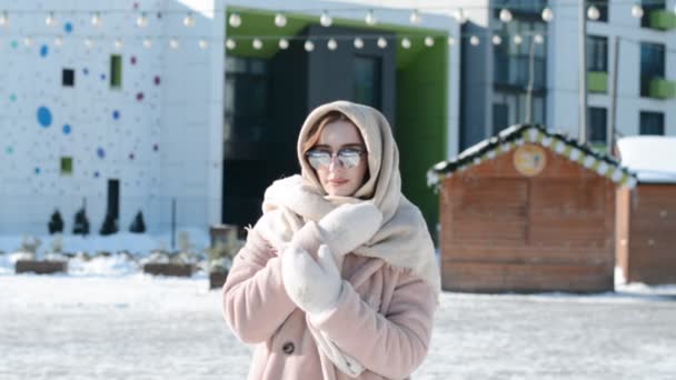 Portret van een prachtig Russisch meisje in de winter in de stad op een zonnige dag — Stockvideo