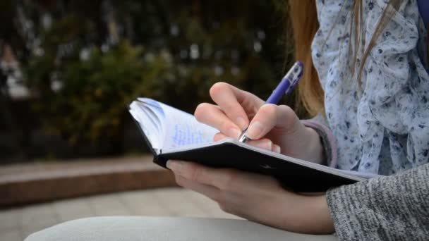 Female student working and making notes — Stock Video