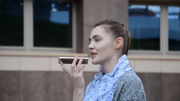 Caucasian young Girl talking on the phone through the speakerphone — Stock Video