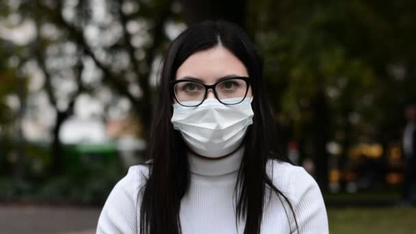 Şehrin yüz resmi koruyucu maske takan bir kadın. — Stok video