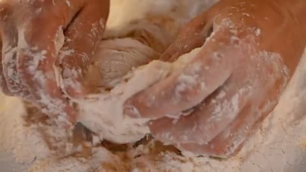 Primer plano de vídeo de las manos del chef de panadería senior aplicando harina en la masa — Vídeos de Stock