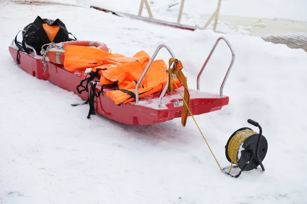 Sled Vermelho Com Jaquetas Segurança Laranja Anel Vida Corda Bobina — Fotografia de Stock