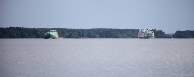 Volga Nehri ticari seyrüsefer trafiği, yazın yüzen yolcu gemisi ve kargo gemisi üzerinde sudan panoramik manzara