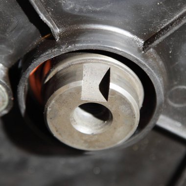 Araba motorunun motor şaftındaki yalıtımlı sürüş teçhizatı kapsama alanı altında.