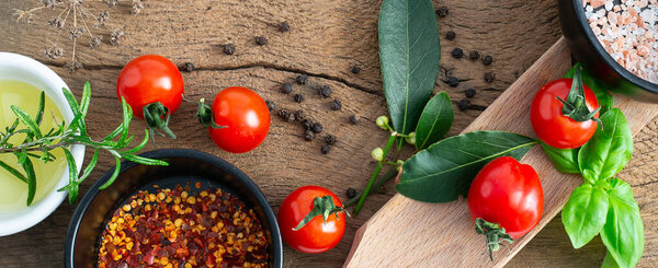 Italian food ingredients, rustic kitchen. Tomatoes, basil, olive oil. Fresh ingredients for pizza, pasta top view