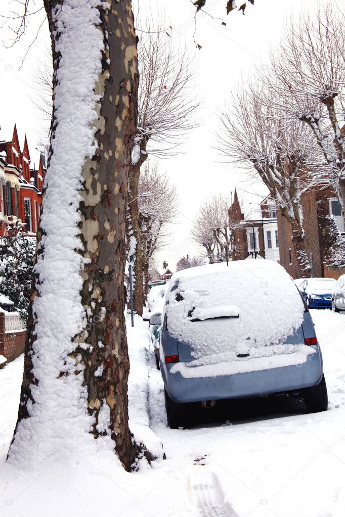 Snow covered cars in a Victorian terraced street