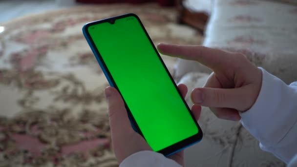 Teenager Looks Information Smartphone Screen Green Background — Αρχείο Βίντεο