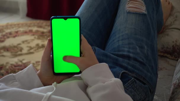 Teenager Looks Information Smartphone Screen Green Background — Wideo stockowe