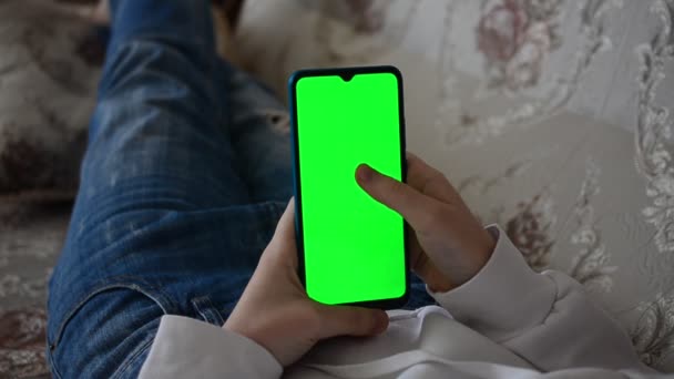 Teenager Looks Information Smartphone Screen Green Background — Stock videók