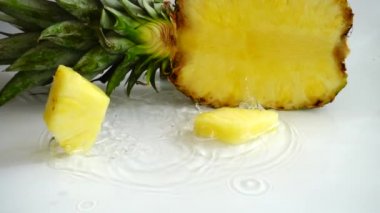 Falling juicy pieces of pineapple. Slow motion.