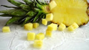 Falling juicy pieces of pineapple. Slow motion.