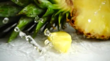 Falling juicy pieces of pineapple. Slow motion.