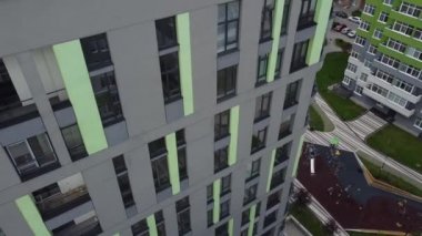 Modern konut binasının üzerinde uçan bir dron görüntüsü.