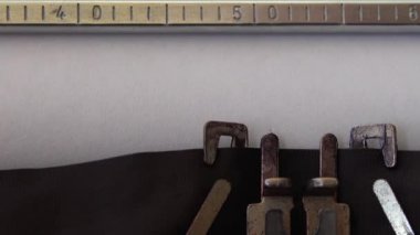 Typing phrase FUCK YOU on retro typewriter. Close up.