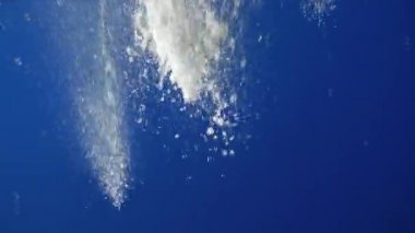 Çeşmenin püskürtüleri gökyüzüne karşı. Yansıma.