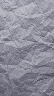 Gri ve kömürün tonlarında çeşitli buruşmuş eko geri dönüşümlü kağıtların hareket animasyonunu durdur. Dizide doğal renklendirme maddesi ve organik bitkisel boyalı el yapımı kağıdın dokulu bir yüzeyi gösteriliyor..