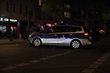 Berlin, Almanya - 01 Mayıs 2021: Polis arabası 1 Mayıs akşamı Berlin 'de bir kavşakta.