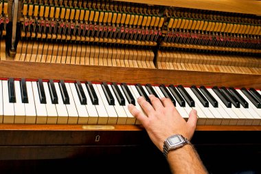 piano tuner plays ,classical tuning of antique piano, musical instrument