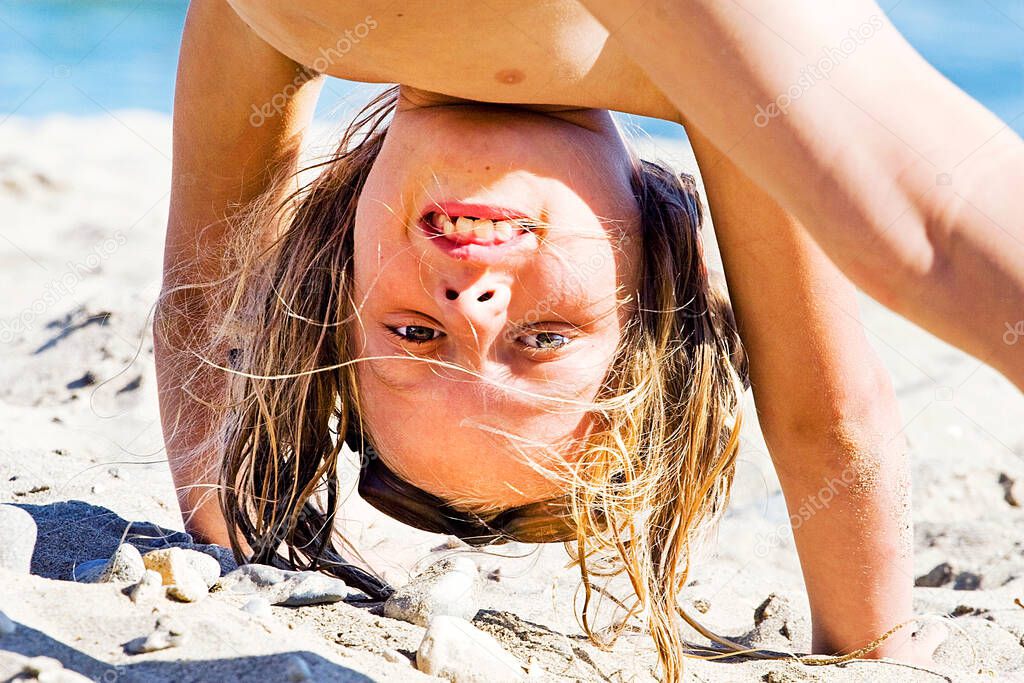 girl upside down,happy girl on the beach with her feet up