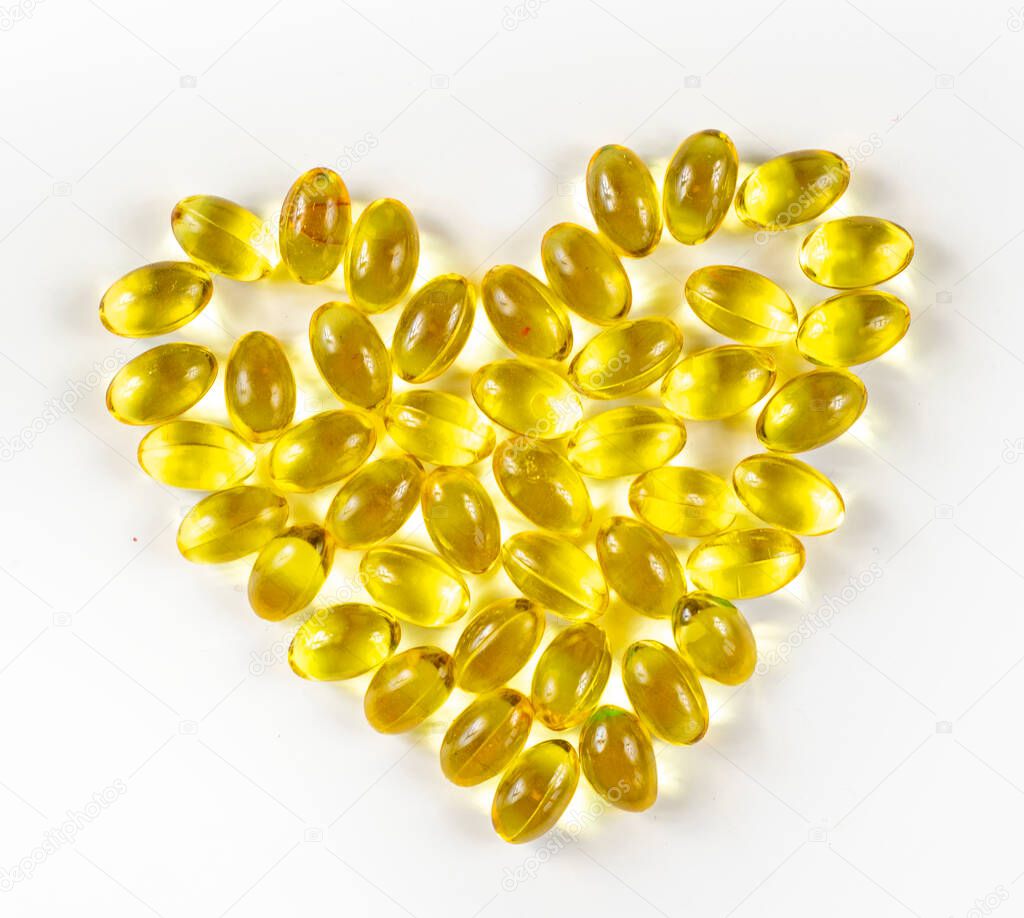 Fish oil from cod liver in capsules for children and adults in the form of a heart on a white background, prevention, 