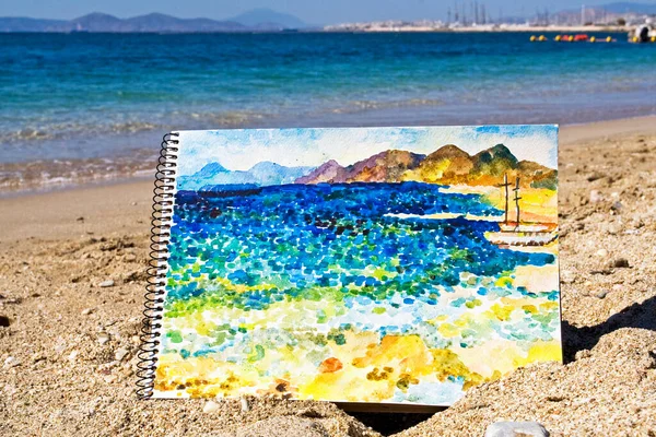 drawing from the nature of the sea on the beach with watercolors