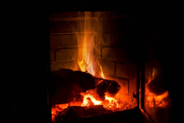 Fire Burns Wood Fireplace Blue Gas Black Background Holiday Lights — Stock Photo, Image