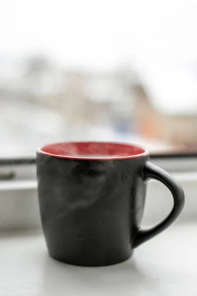 smoking hot cup with a drink on a quiet in the morning, vertical