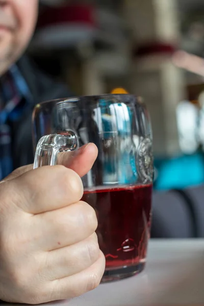 drinking red cider in a glass goblet, vertica