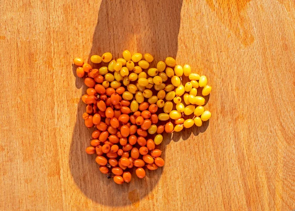 good morning heart with sea buckthorn on a wooden surface, horizonta