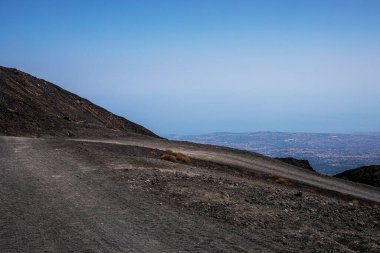 Beautiful scenery of Sicily and a road with the active volcano Etna during the day. Traveling in Italy