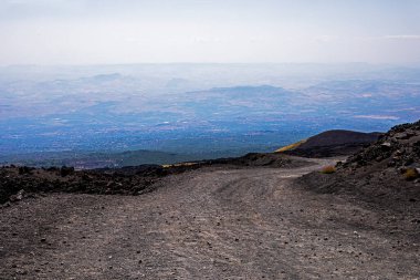 Road to the ascent and descent of Etna Volcano with a beautiful view of Sicily. Mountain tourism