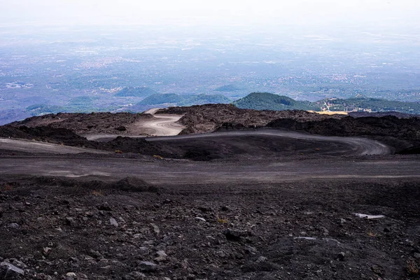 Beautiful scenery of Sicily and a road with the active volcano Etna during the day. Traveling in Italy