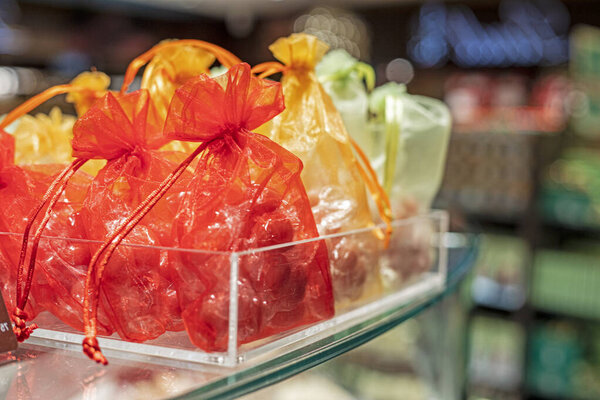 Yellow and red organza gift bags. Christmas preparations.