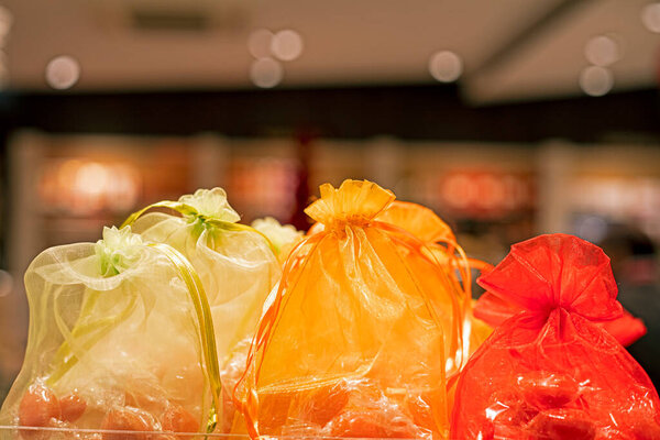 Yellow and red organza gift bags. Christmas preparations.
