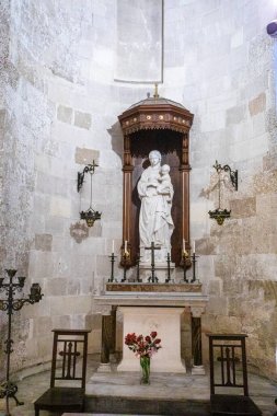 Meryem Ana 'nın mermer heykeli ve çocuk kilisede sunakta. Dini bayram