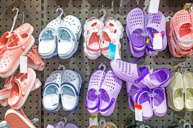 Summer rubber multicolored rubber Crocs and slippers at the supermarket. Start of the season.