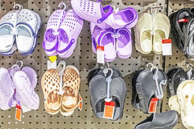 Colorful rubber Crocs and slippers at the supermarket. Start of the season.