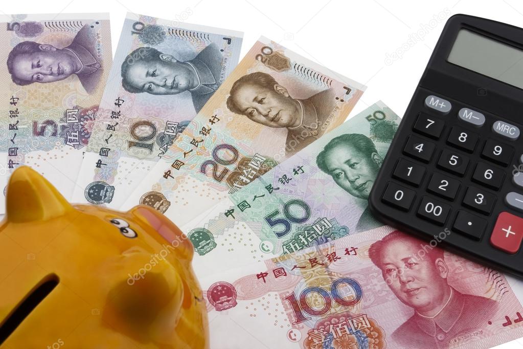 Chinese money (RMB), piggy bank and a calculator. 