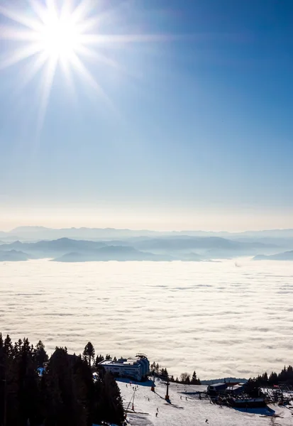 View on mountains and sun above clouds