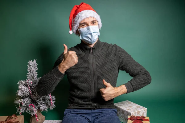 Man with many wrapped gifts on green background Royalty Free Stock Photos