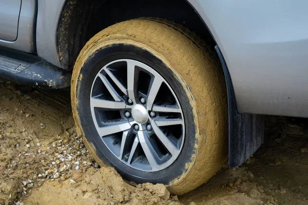 Car wheels stuck in mud