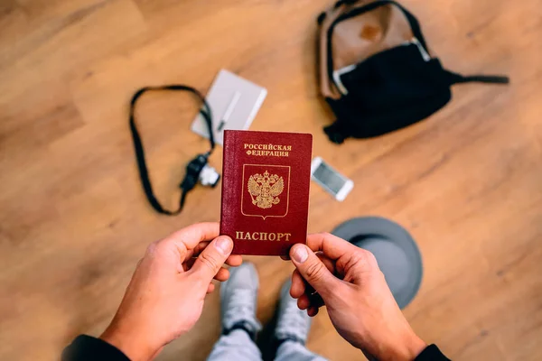 Man Holds Russian Passport Backpack Travel Accessories Background Concept Travel — Stock Photo, Image