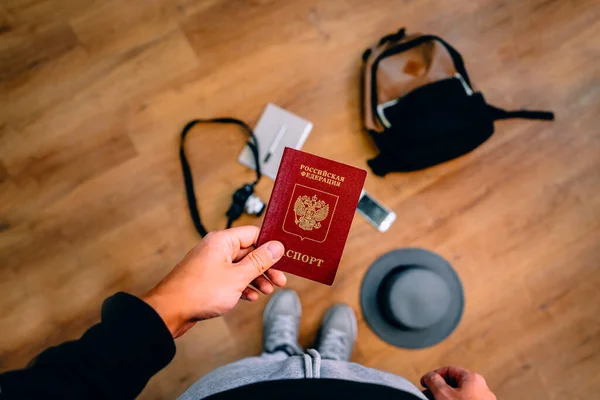 Man Holds Russian Passport Backpack Travel Accessories Background Concept Travel — Stock Photo, Image