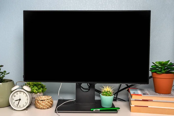 A cozy workplace with plants and a monitor for copy space. Office style desktop for desktop computer with keyboard