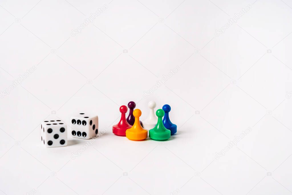 Colored playing chips and dice on a white background