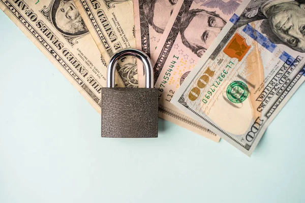Locked lock on banknotes as a concept of financial security of deposits and money storage