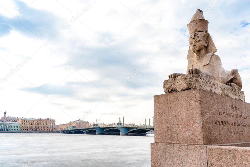  Embankment of St. Petersburg with sculptures in the form of sphinxes, ice on the water. St Petersburg, Russia - 28 Mar 2021