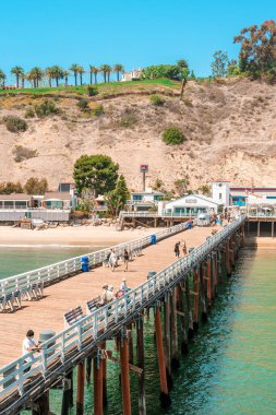 Malibu Beach pier, California. Postcard view, blue sky and beautiful ocean waves clipart