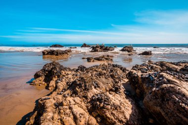 Matador beach and beautiful landscape with rocks and ocean against blue sky, California clipart